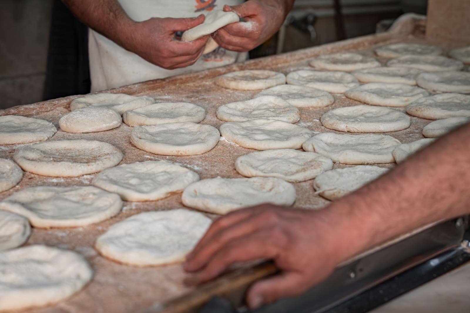 Flatbread carried home across both forearms.