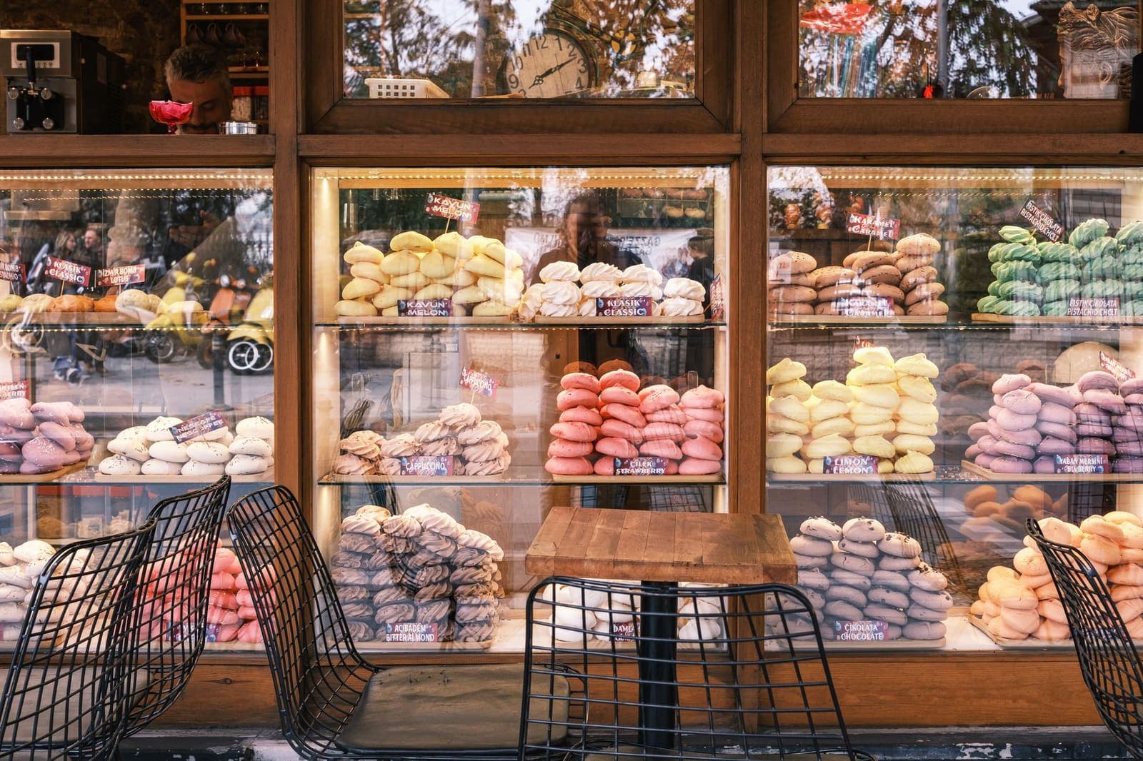 A bakery window lit after dark, the rest of the street unlit.