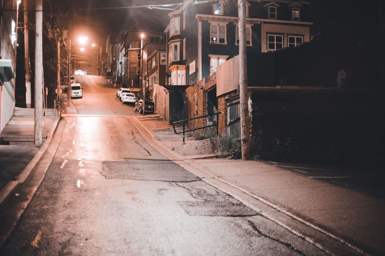 An empty street just before dusk, doors closed.