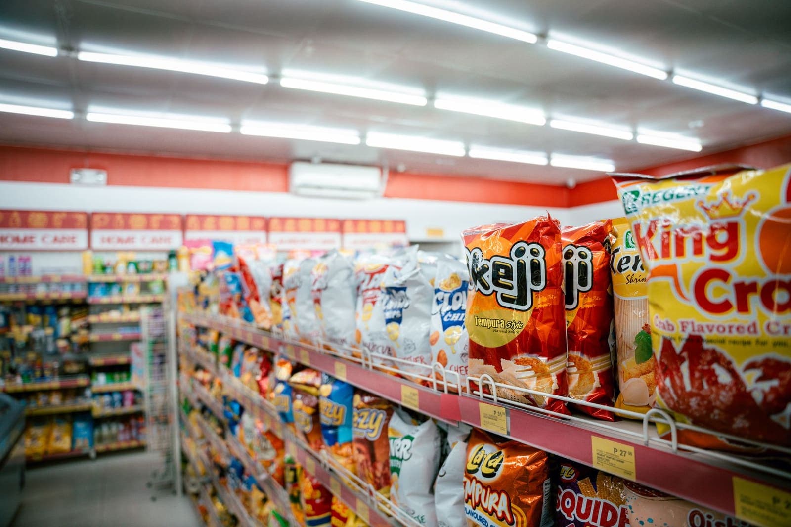 The inside of a narrow shop, stock stacked to the ceiling.
